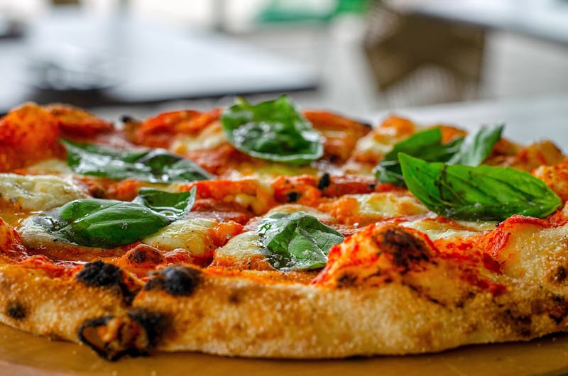 Freshly baked Neapolitan pizza with basil and mozzarella